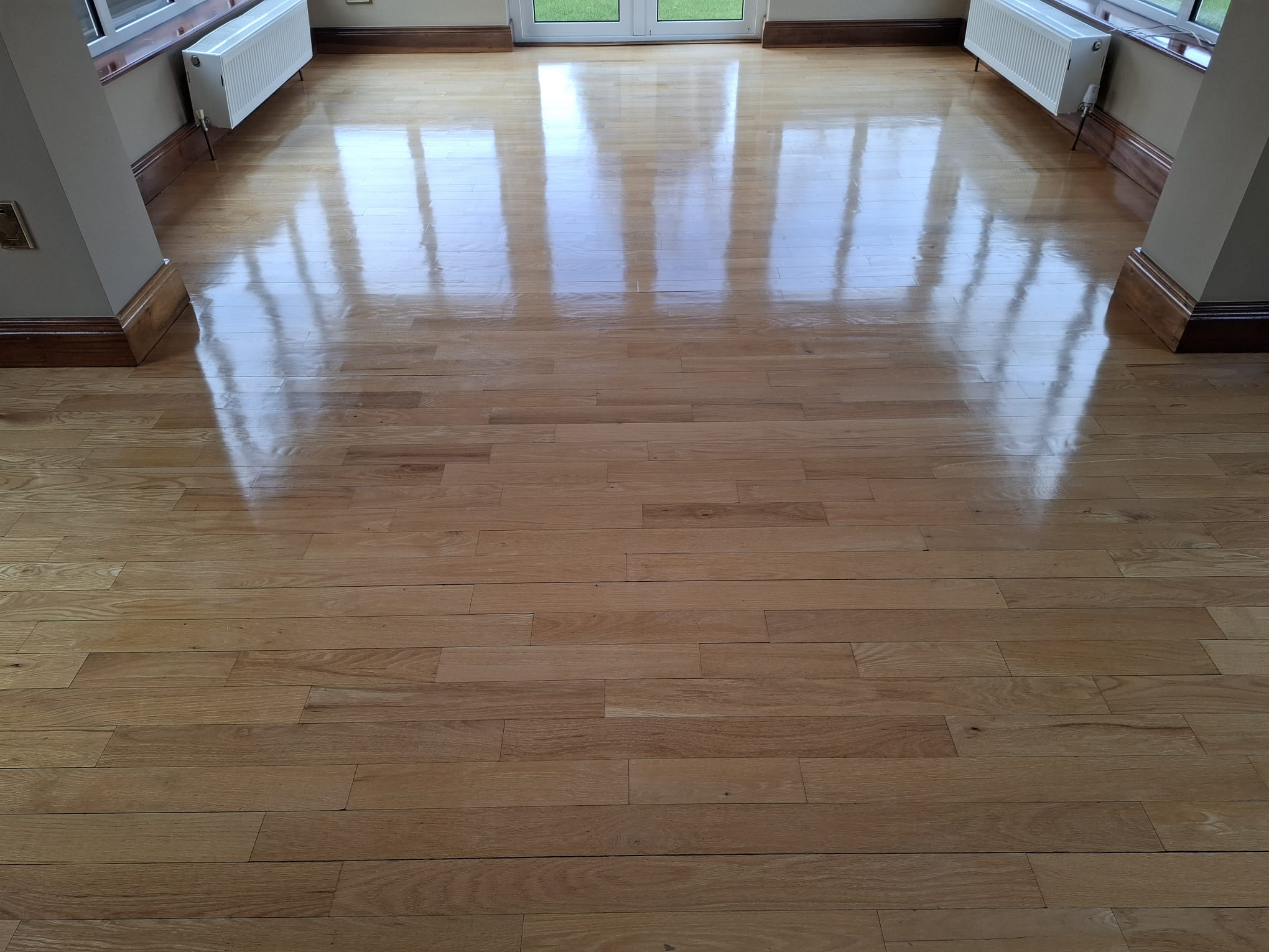 Restored oak floor re-finished to a warm, even sheen