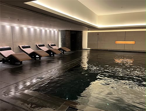 Spa relaxation pool at Powerscourt Hotel — dark stone poolside floor cleaned and sealed