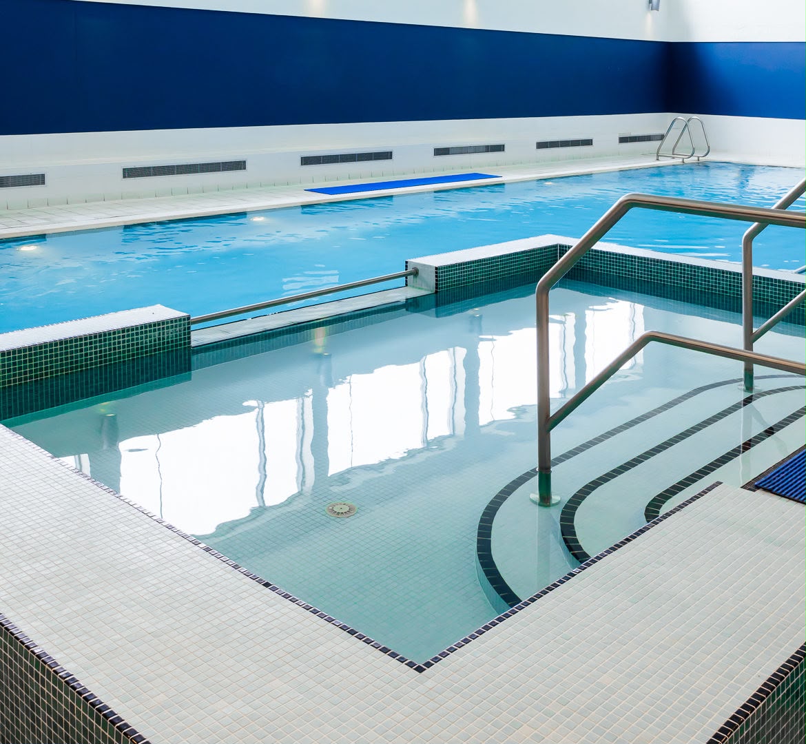 Hydrotherapy pool at a Só Hotels leisure centre — white-tiled deck and steps kept clean and slip-resistant